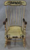 A late 19th century stick back rocking chair with its original all over floral painted decoration.