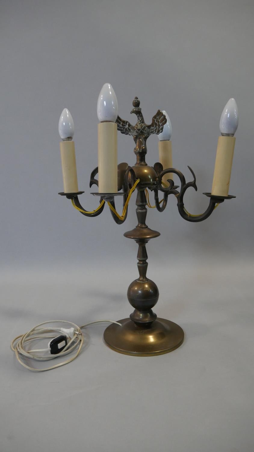 A vintage brass four branch table candelabra with spread eagle finial. H.52cm