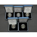 Five Royal Mint one pound silver proof coins. All in pale blue presentation cases with COA's.