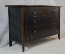 A Chinese black lacquered chest with faux bamboo style frame and swept supports. H.83 W.130 D.50cm