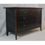 A Chinese black lacquered chest with faux bamboo style frame and swept supports. H.83 W.130 D.50cm