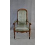 A 19th century French provincial beech framed armchair in damask upholstery on cabriole supports.