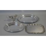 Three silver plated serving trays and a WMF gravy boat with scrolling handle and maker's stamp to