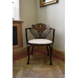 An Edwardian mahogany salon armchair with profuse satinwood and ivory foliate, swag and urn inlay