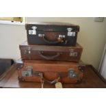 A small leather case fitted with filing drawers, a vintage leather suitcase and another vintage