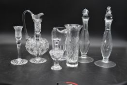 A small signed Lalique jar and stopper along with a pair of cut crystal candlesticks, a pair of