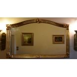 A 19th century style gilt framed overmantel mirror with arched plate and floral cresting. H.90cm W.