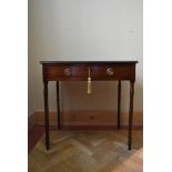 A Georgian mahogany side table fitted with frieze drawer on slender ring turned tapering supports.