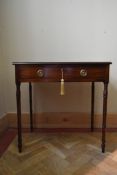 A Georgian mahogany side table fitted with frieze drawer on slender ring turned tapering supports.