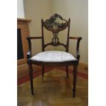 A late 19th century carved walnut salon armchair with hand painted back panel on fluted tapering