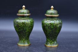A pair of Chinese cloisonné lidded vases with all over floral enamel decoration. H.23cm