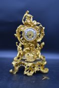 A French style mantel clock in gilt metal Rococo style case decorated with cherubs resting on