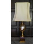 A brass and metal table lamp on a Classical style socle base. H.84cm W.40cm