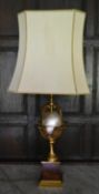 A brass and metal table lamp on a Classical style socle base. H.84cm W.40cm