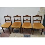 A set of four late 19th century walnut dining chairs with profuse ebony and satinwood inlay to the