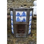 A late 19th century Dutch steel free standing fireplace with inset blue and white sailboat tiles