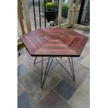 A stained pine conservatory table on metal hairpin base. H.76 W.106cm