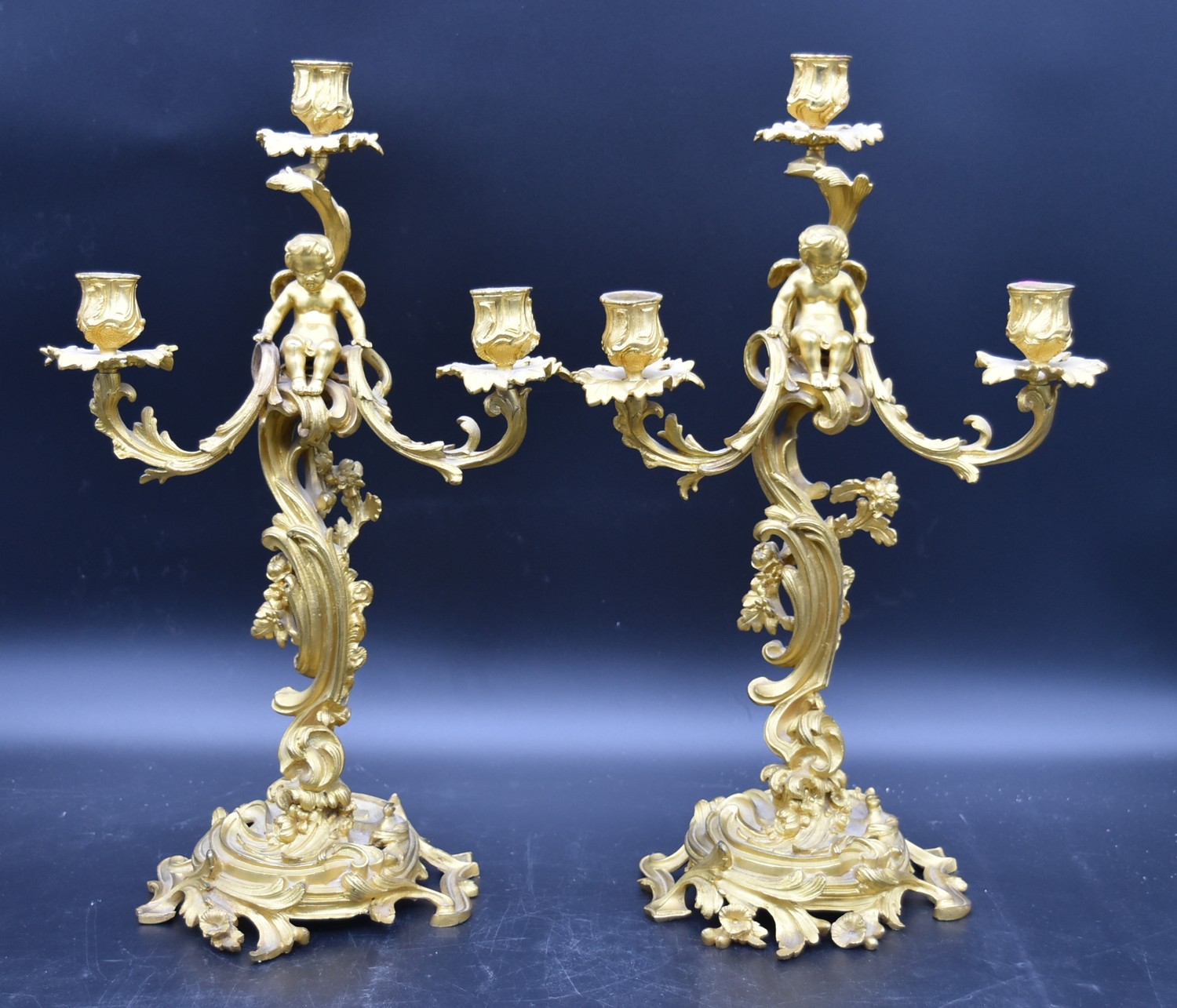 A pair of gilt metal three branch table candelabras with cherub surmounts raised on Rococo scrolling - Image 2 of 5