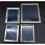 A collection of four silver easel picture frames each bearing an English hallmark. H.30cm W.25cm (