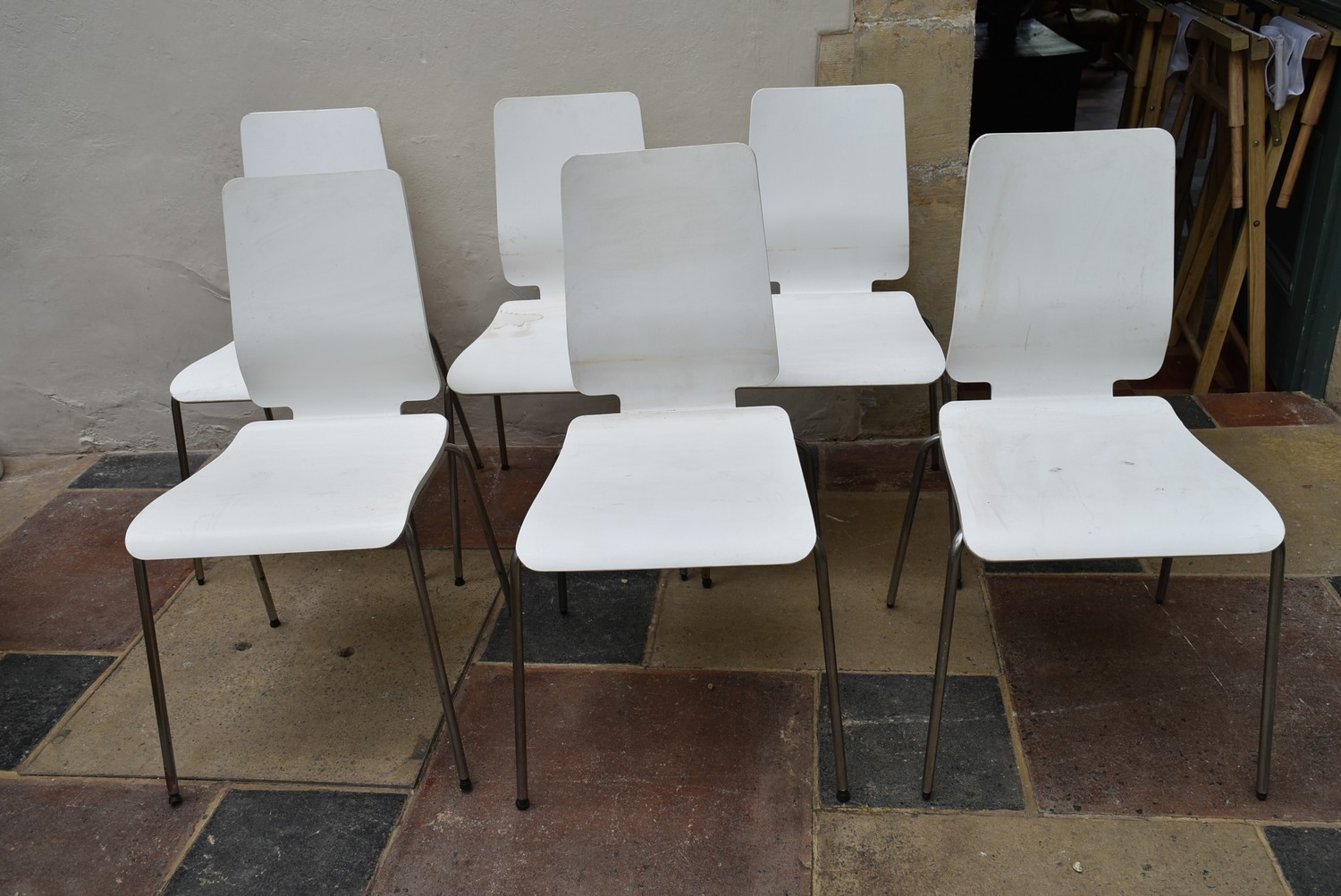 A set of six painted laminated dining chairs on tubular chrome bases. H.90 W.42cm