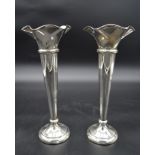 A pair of tall silver trumpet shaped spill vases with wavy rims, hallmarked Walker & Hall,