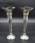 A pair of tall silver trumpet shaped spill vases with wavy rims, hallmarked Walker & Hall,