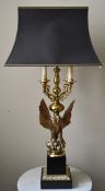 A heavy brass four branch table candelabra lamp in the shape of a spread winged eagle on a classical