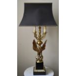 A heavy brass four branch table candelabra lamp in the shape of a spread winged eagle on a classical