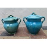 A pair of Eastern turquoise glazed lidded storage pots with twin rope design handles. H.47 Dia.