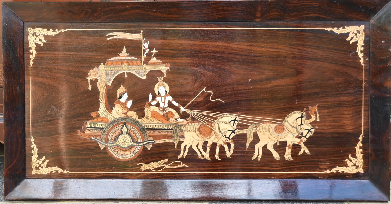 An inlaid Eastern rosewood panel depicting a couple in a ceremonial carriage in a rosewood frame.