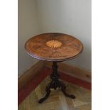 A 19th century burr walnut occasional table with central inlaid paterae raised on carved tripod