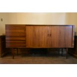 H W Klein for Bramin, a rosewood sideboard with a pair of tambour doors enclosing shelves along with