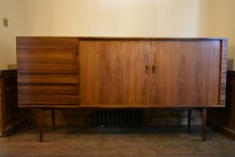 H W Klein for Bramin, a rosewood sideboard with a pair of tambour doors enclosing shelves along with