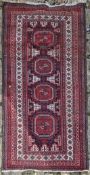 An Eastern rug with repeating gul medallions contained by multiple geometric borders. L.160 W.90cm