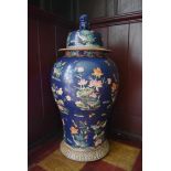 A large Chinese lidded temple jar with all over lotus flower, crane and dragonfly decoration. H.84cm