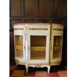 A Louis XV style ormolu mounted and painted credenza with rouge marble top above glazed doors