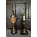 A brass table lamp in the shape of a Classical urn along with another brass table lamp and a