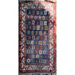 A Heriz rug with repeating stylised star motifs across a sapphire ground within geometric multiple