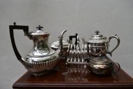 Five items of silver plated ware; a coffee pot, two teapots, a milk jug and a toast rack. H.32cm