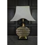 A heavy brass Chinese style table lamp base with white flared shade. H.72cm W.30cm