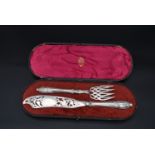 A pair of cased silver pierced and engraved fish servers, HA for Atkin Brothers, Sheffield, 1856.