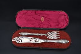 A pair of cased silver pierced and engraved fish servers, HA for Atkin Brothers, Sheffield, 1856.