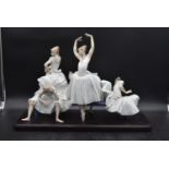 A Lladro figure group, classical ballerinas preparing for a performance, maker's impressed mark to