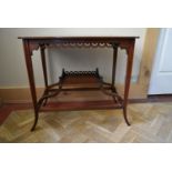 An Edwardian mahogany occasional table with central satinwood urn inlaid medallion on swept supports