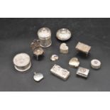 A miscellaneous collection of English and Continental silver and white metal lidded pill boxes,