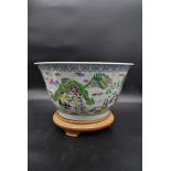 A large Chinese famille vert bowl with character marks to its base on hardwood stand. H.27cm Dia.