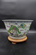 A large Chinese famille vert bowl with character marks to its base on hardwood stand. H.27cm Dia.