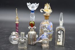 A collection of eight glass perfume bottles, hand painted and silver mounted, various hallmarks, H.