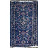 A Bidjar rug with central scrolling foliate medallion on a sapphire ground within floral borders.