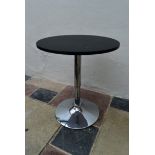 A contemporary occasional table with rise and fall action on chrome tulip base. H.70 W.60cm